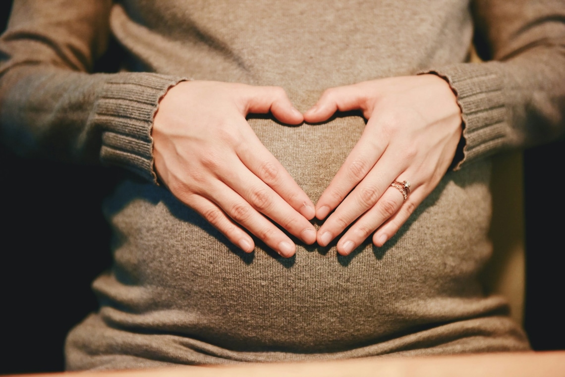 https://unsplash.com/photos/person-holding-belly-photo-NIZeg731LxM