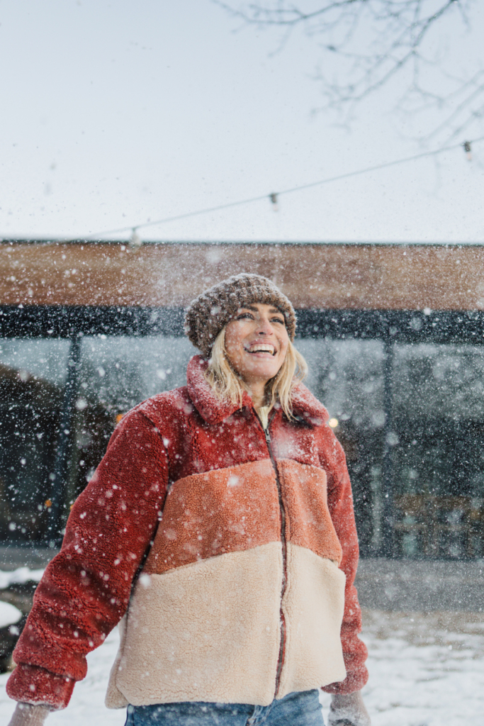 Vidám nő a hóesésben