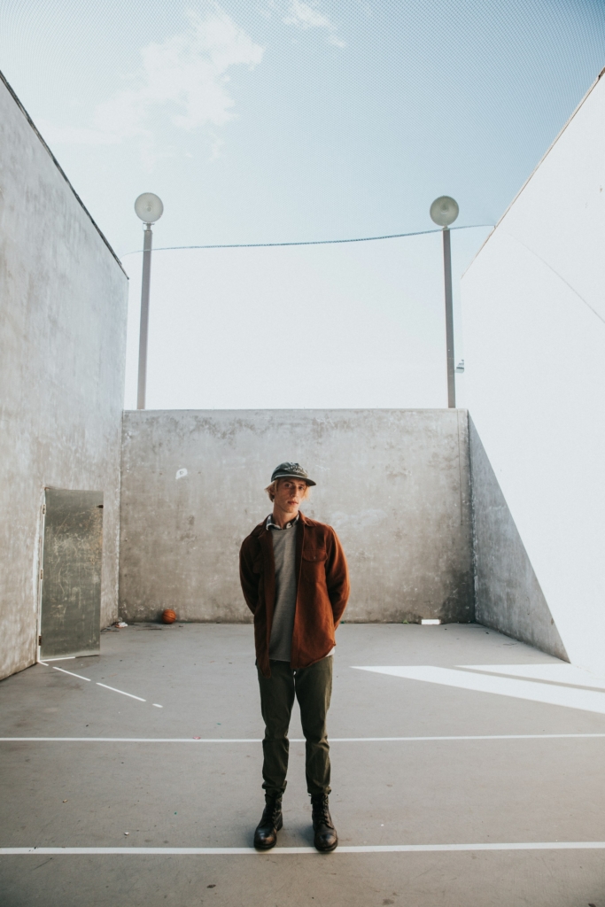 Fiatal srác egy deszkás parkban áll