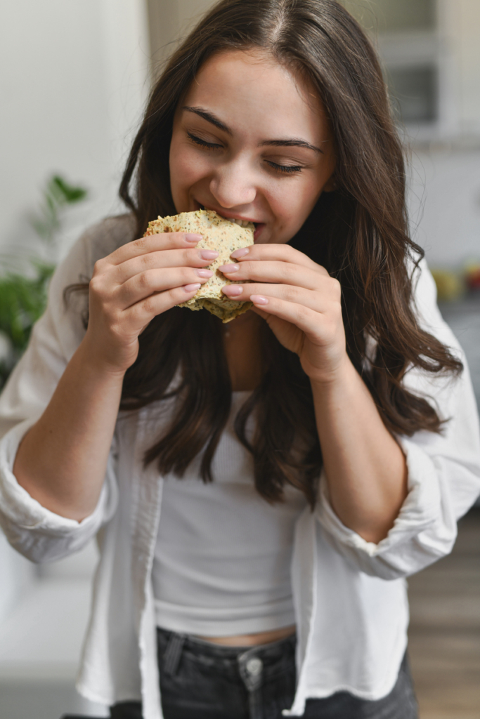 Nő egy tortilla tekercset eszik