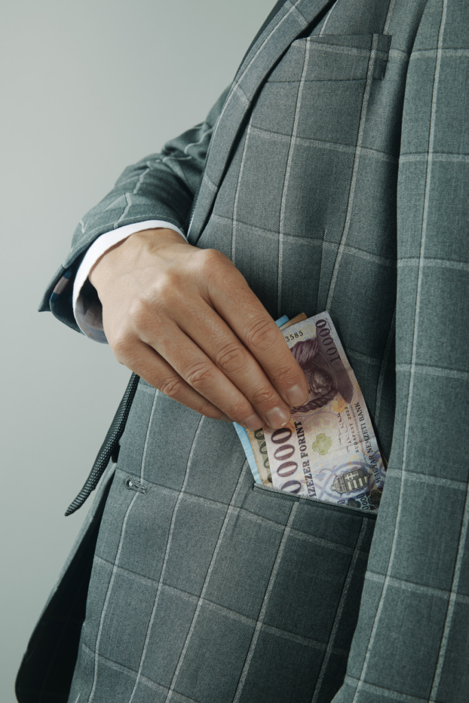 Man putting forints into his jacket pocket