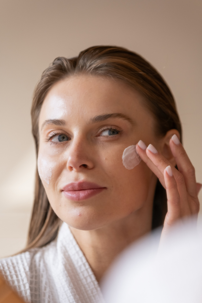 Woman applying face cream