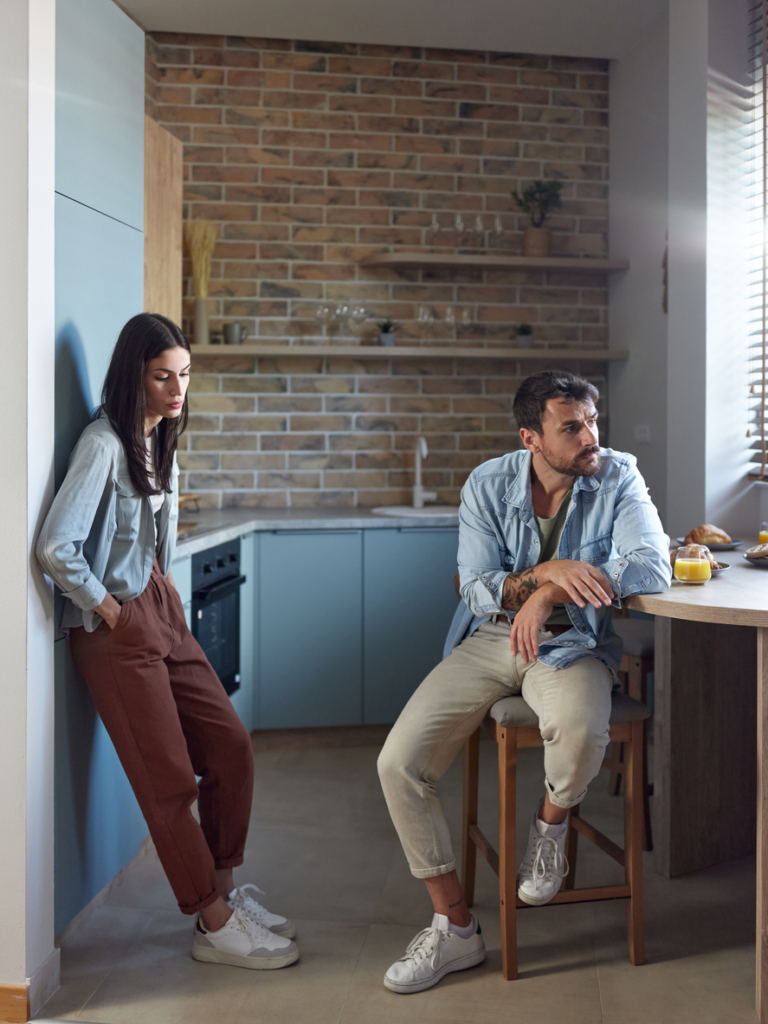 Párkapcsolati gondok: pár gondterhelten ül egymástól távol a konyhában