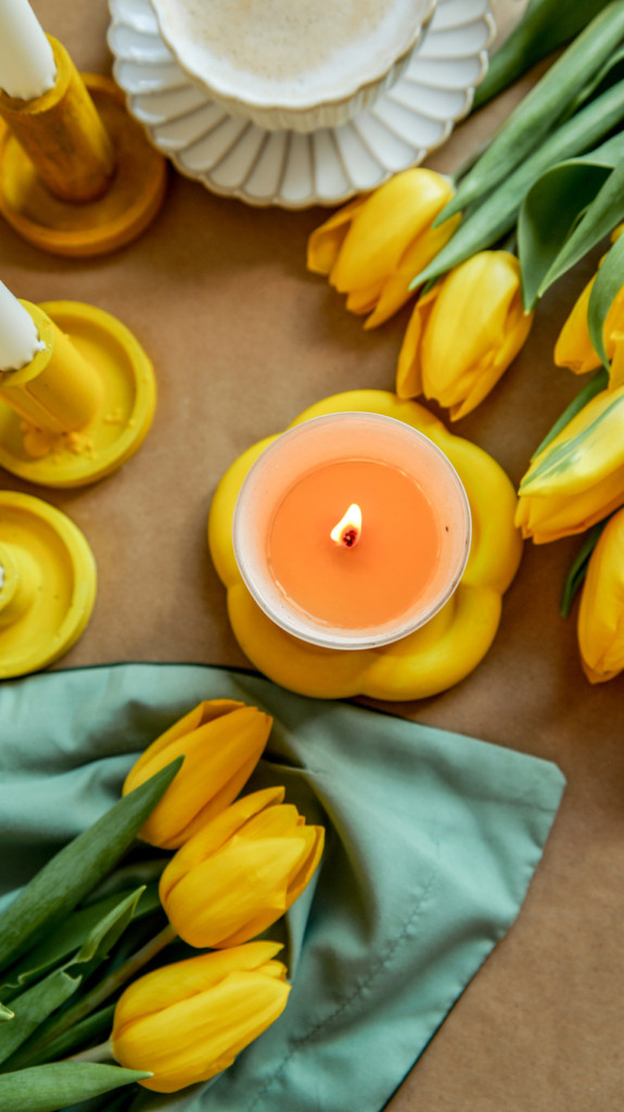 Tavaszi illatú szójagyertya, mellette sárga tulipánok