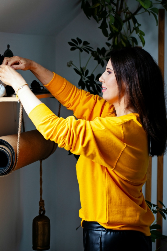 Nő rendezgeti a tárgyait otthon