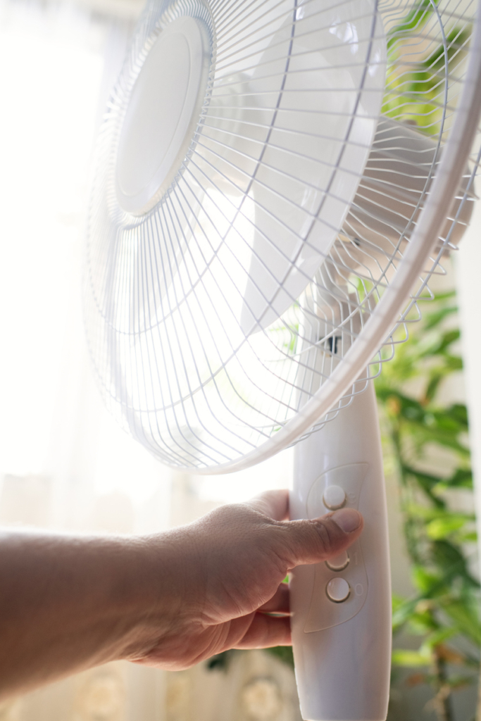 Női kéz kapcsol egy ventilátort